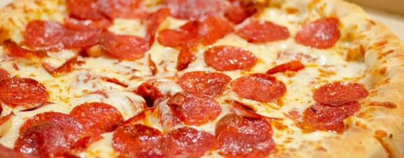 A pizza topped with pepperoni, which pregnant women can only eat if thoroughly cooked.