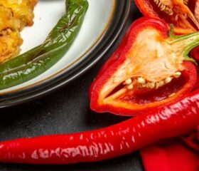 Arrangement of different kinds of peppers on a table.