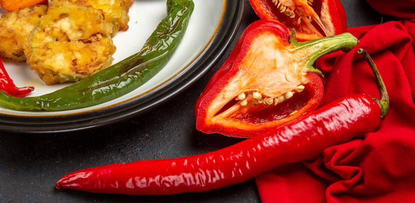 Arrangement of different kinds of peppers on a table.