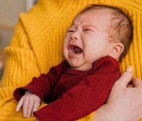A colicky baby crying inconsolably.
