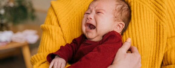 A colicky baby crying inconsolably.