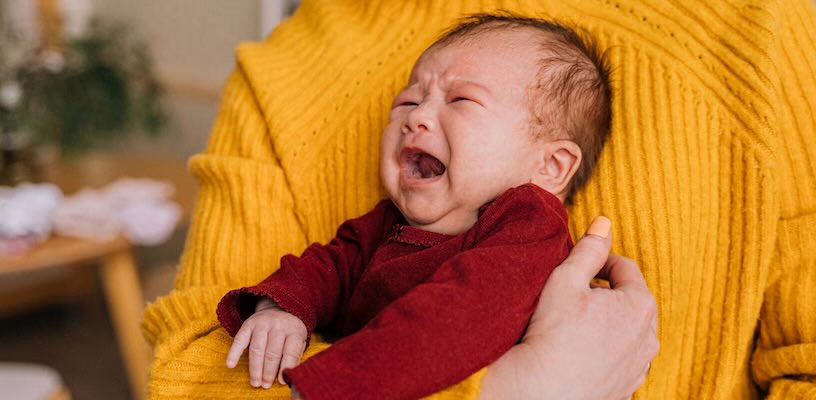 A colicky baby crying inconsolably.