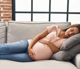 Pregnant women with gestational diabetes resting on the couch.