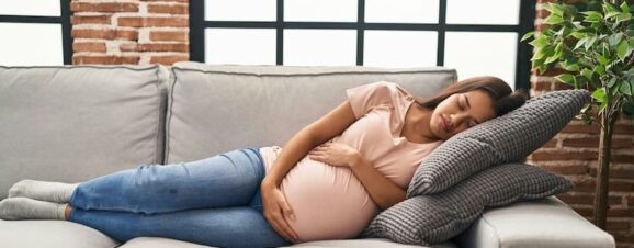 Pregnant women with gestational diabetes resting on the couch.