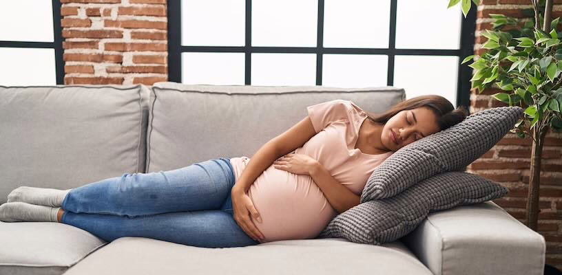 Pregnant women with gestational diabetes resting on the couch.