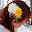 The side of a woman's head with a big yellow and white flower in her hair.