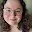 Selfie of a woman with brown, curly hair.