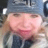 A close-up selfie of a woman wearing a grey beanie.
