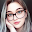 Picture of a woman with glasses looking directly into the camera.