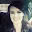 Picture of a smiling woman taking a selfie in a car.