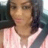 Close-up selfie of a woman in a car with her seatbelt on.
