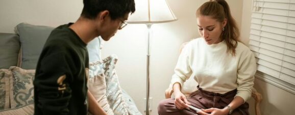 Woman with PCOS checking an ovulation test while sitting next to her partner.