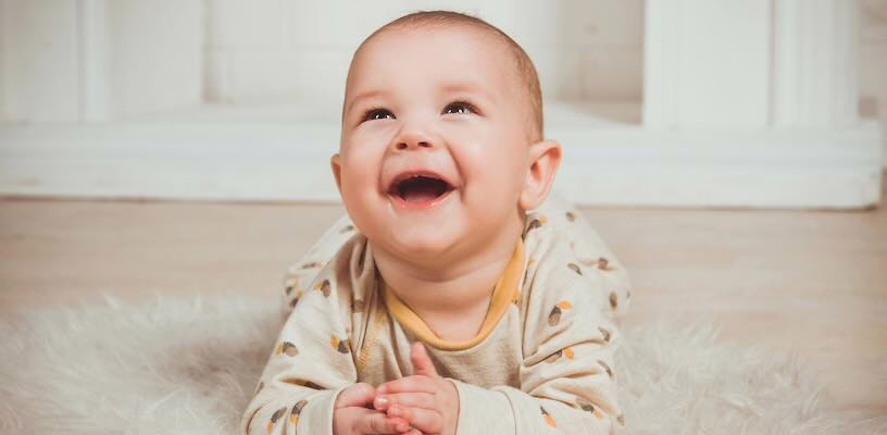Closeup of a baby laughing.