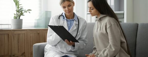 Doctor explaining the process of egg freezing to her young female patient.