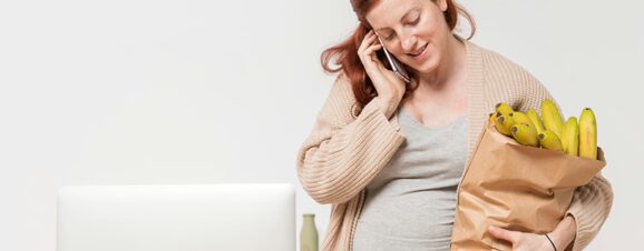 Pregnant women carrying a heavy bag of groceries.